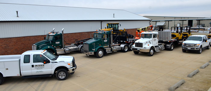 Trucks parked out of Unzicker Equipment Inc. service department exterior